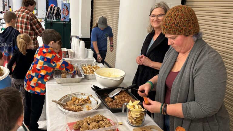 Photo of volunteers serving families at Reaching Out Now Family Night Out events